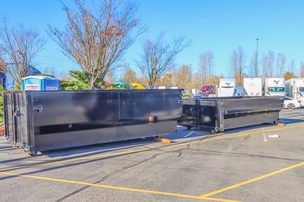 Professional dumpster rental service with roll-off container on residential driveway in Reynoldsburg